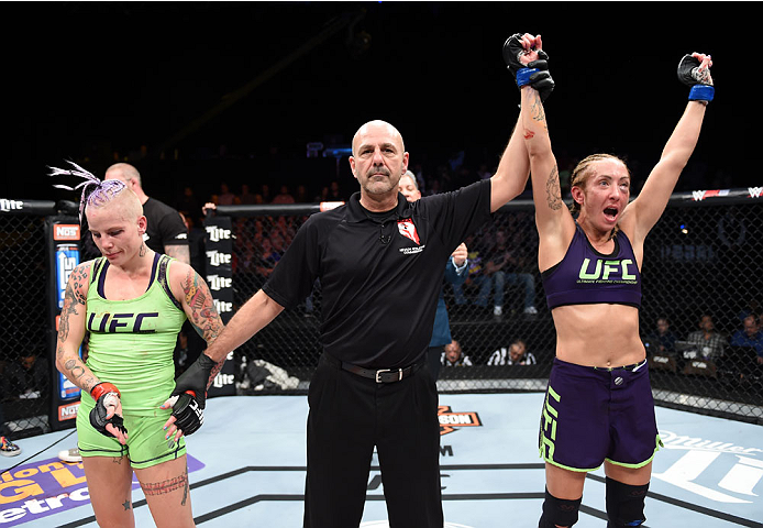 LAS VEGAS, NEVADA - DECEMBER 12: (R-L) Heather Jo Clark raises her hands after her victory over Bec Rawlings in their strawweight fight during The Ultimate Fighter Finale event inside the Pearl concert theater at the Palms Casino Resort on December 12, 20