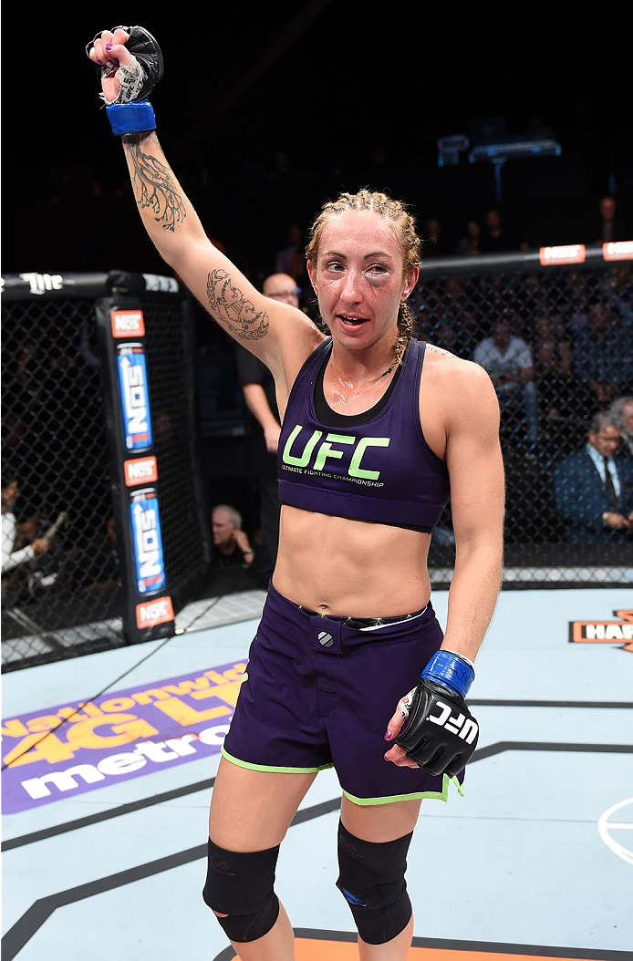 LAS VEGAS, NEVADA - DECEMBER 12: Heather Jo Clark raises her hands after her fight against Bec Rawlings in their strawweight fight during The Ultimate Fighter Finale event inside the Pearl concert theater at the Palms Casino Resort on December 12, 2014 in