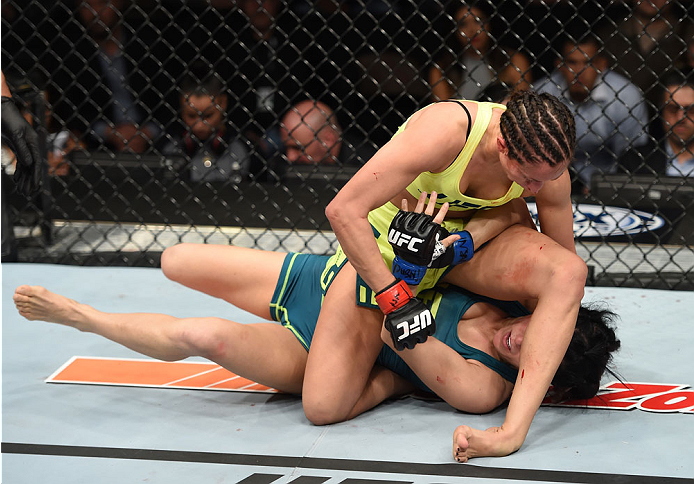LAS VEGAS, NEVADA - DECEMBER 12: Jessica Penne (top) controls the body of Randa Markos in their strawweight fight during The Ultimate Fighter Finale event inside the Pearl concert theater at the Palms Casino Resort on December 12, 2014 in Las Vegas, Neva