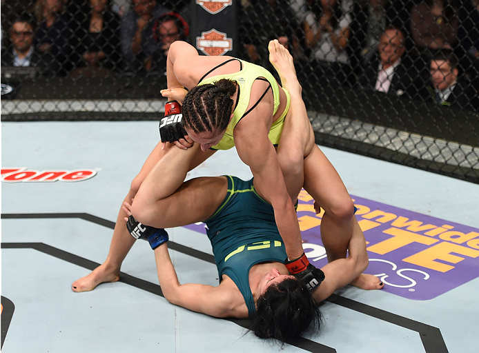 LAS VEGAS, NEVADA - DECEMBER 12: Jessica Penne (top) punches Randa Markos in their strawweight fight during The Ultimate Fighter Finale event inside the Pearl concert theater at the Palms Casino Resort on December 12, 2014 in Las Vegas, Nevada. (Photo by