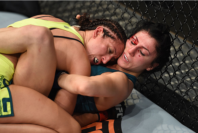 LAS VEGAS, NEVADA - DECEMBER 12: Jessica Penne (top) pushes Randa Markos against the cage in their strawweight fight during The Ultimate Fighter Finale event inside the Pearl concert theater at the Palms Casino Resort on December 12, 2014 in Las Vegas, N