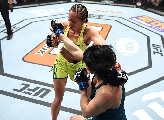 LAS VEGAS, NEVADA - DECEMBER 12: (L-R) Jessica Penne exchanges punches with Randa Markos in their strawweight fight during The Ultimate Fighter Finale event inside the Pearl concert theater at the Palms Casino Resort on December 12, 2014 in Las Vegas, Ne