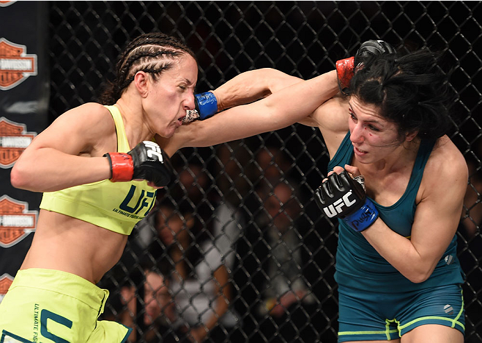 LAS VEGAS, NEVADA - DECEMBER 12: (L-R) Jessica Penne exchanges punches with Randa Markos in their strawweight fight during The Ultimate Fighter Finale event inside the Pearl concert theater at the Palms Casino Resort on December 12, 2014 in Las Vegas, Ne