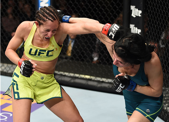 LAS VEGAS, NEVADA - DECEMBER 12: (L-R) Jessica Penne exchanges punches with Randa Markos in their strawweight fight during The Ultimate Fighter Finale event inside the Pearl concert theater at the Palms Casino Resort on December 12, 2014 in Las Vegas, Ne