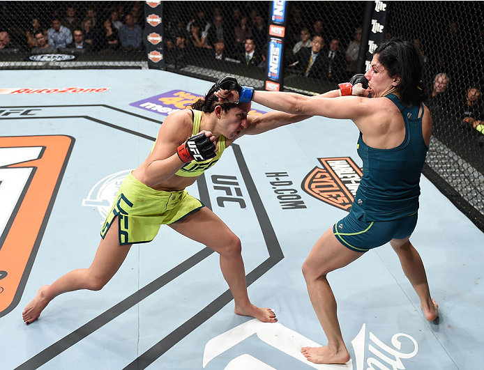 LAS VEGAS, NEVADA - DECEMBER 12: (L-R) Jessica Penne exchanges punches with Randa Markos in their strawweight fight during The Ultimate Fighter Finale event inside the Pearl concert theater at the Palms Casino Resort on December 12, 2014 in Las Vegas, Ne