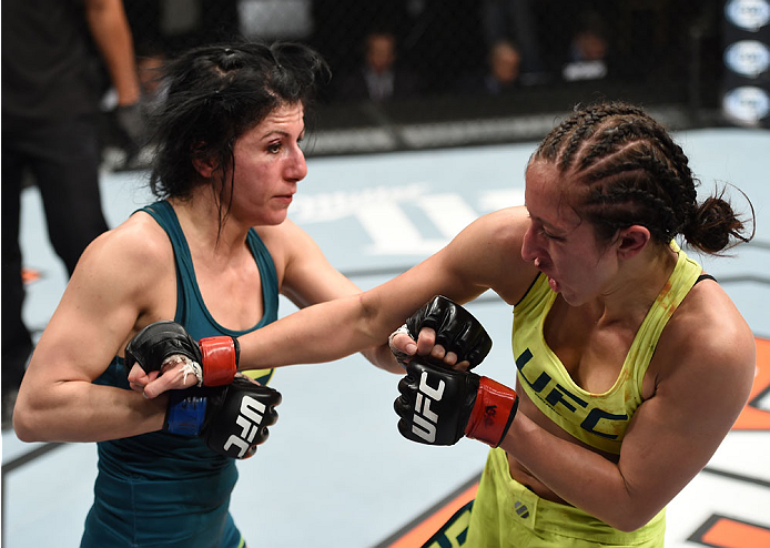 LAS VEGAS, NEVADA - DECEMBER 12: (R-L) Jessica Penne exchanges punches with Randa Markos in their strawweight fight during The Ultimate Fighter Finale event inside the Pearl concert theater at the Palms Casino Resort on December 12, 2014 in Las Vegas, Ne