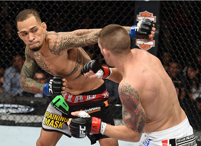 LAS VEGAS, NEVADA - DECEMBER 12: (L-R) Yancy Medeiros punches Joe Proctor in their lightweight fight during The Ultimate Fighter Finale event inside the Pearl concert theater at the Palms Casino Resort on December 12, 2014 in Las Vegas, Nevada. (Photo by