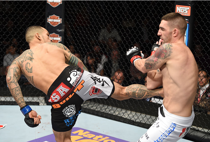 LAS VEGAS, NEVADA - DECEMBER 12: (L-R) Yancy Medeiros kicks Joe Proctor in their lightweight fight during The Ultimate Fighter Finale event inside the Pearl concert theater at the Palms Casino Resort on December 12, 2014 in Las Vegas, Nevada. (Photo by Je