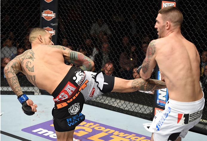 LAS VEGAS, NEVADA - DECEMBER 12: (L-R) Yancy Medeiros kicks Joe Proctor in their lightweight fight during The Ultimate Fighter Finale event inside the Pearl concert theater at the Palms Casino Resort on December 12, 2014 in Las Vegas, Nevada. (Photo by Je