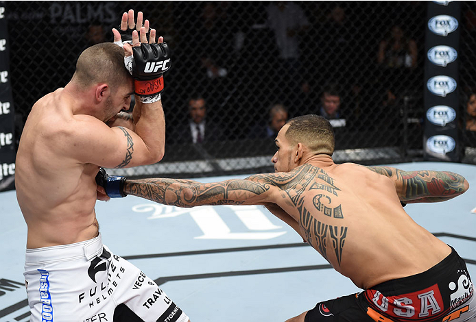 LAS VEGAS, NEVADA - DECEMBER 12: (R-L) Yancy Medeiros punches Joe Proctor in their lightweight fight during The Ultimate Fighter Finale event inside the Pearl concert theater at the Palms Casino Resort on December 12, 2014 in Las Vegas, Nevada. (Photo by