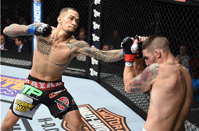LAS VEGAS, NEVADA - DECEMBER 12: (L-R) Yancy Medeiros punches Joe Proctor in their lightweight fight during The Ultimate Fighter Finale event inside the Pearl concert theater at the Palms Casino Resort on December 12, 2014 in Las Vegas, Nevada. (Photo by