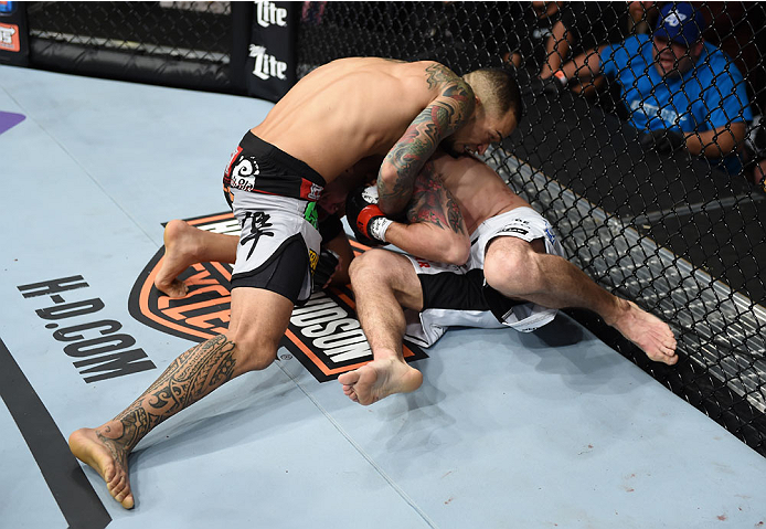 LAS VEGAS, NEVADA - DECEMBER 12: (L-R) Yancy Medeiros attempts to submit Joe Proctor in their lightweight fight during The Ultimate Fighter Finale event inside the Pearl concert theater at the Palms Casino Resort on December 12, 2014 in Las Vegas, Nevada.