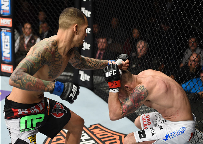 LAS VEGAS, NEVADA - DECEMBER 12: (L-R) Yancy Medeiros punches Joe Proctor in their lightweight fight during The Ultimate Fighter Finale event inside the Pearl concert theater at the Palms Casino Resort on December 12, 2014 in Las Vegas, Nevada. (Photo by