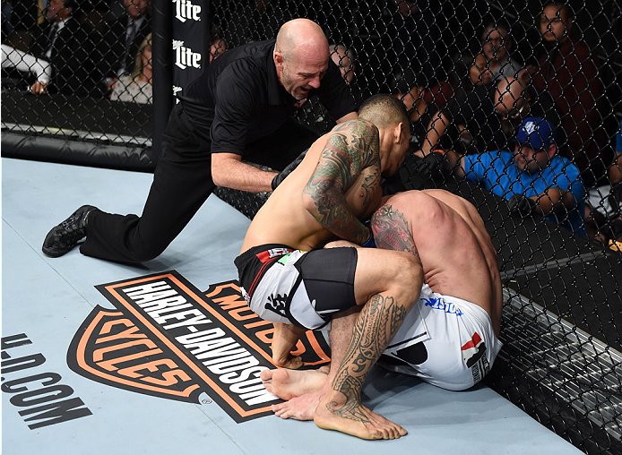 LAS VEGAS, NEVADA - DECEMBER 12: (L-R) Yancy Medeiros submits Joe Proctor in their lightweight fight during The Ultimate Fighter Finale event inside the Pearl concert theater at the Palms Casino Resort on December 12, 2014 in Las Vegas, Nevada. (Photo by