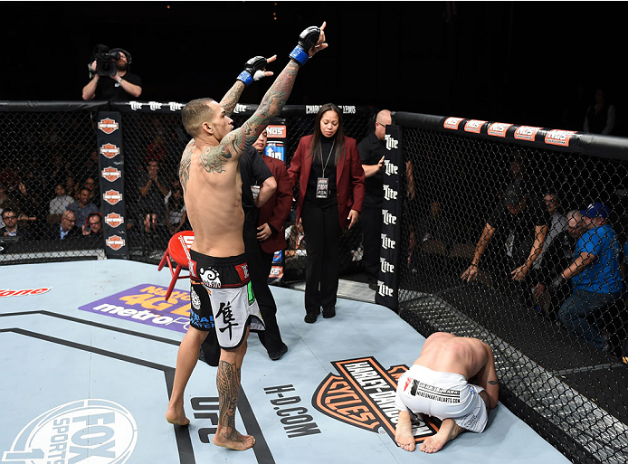 LAS VEGAS, NEVADA - DECEMBER 12: (L-R) Yancy Medeiros celebrates his submission victory over Joe Proctor in their lightweight fight during The Ultimate Fighter Finale event inside the Pearl concert theater at the Palms Casino Resort on December 12, 2014 i