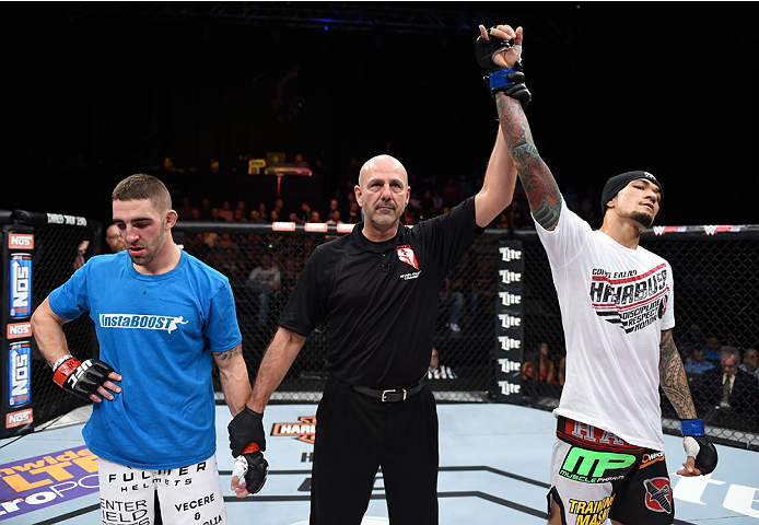 LAS VEGAS, NEVADA - DECEMBER 12: (R-L)Yancy Medeiros celebrates his submission victory over Joe Proctor in their lightweight fight during The Ultimate Fighter Finale event inside the Pearl concert theater at the Palms Casino Resort on December 12, 2014 in