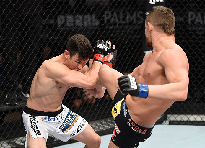 LAS VEGAS, NEVADA - DECEMBER 12: (R-L) Daron Cruickshank kicks KJ Noons in their lightweight fight during The Ultimate Fighter Finale event inside the Pearl concert theater at the Palms Casino Resort on December 12, 2014 in Las Vegas, Nevada. (Photo by Je