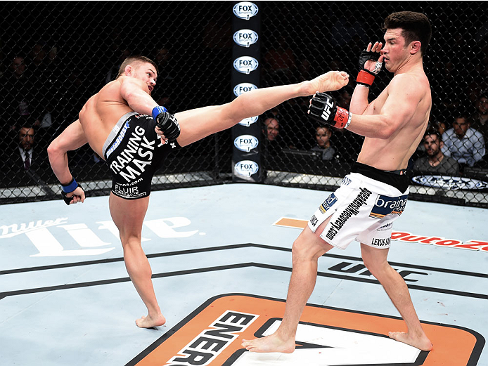 LAS VEGAS, NEVADA - DECEMBER 12: (L-R) Daron Cruickshank kicks KJ Noons in their lightweight fight during The Ultimate Fighter Finale event inside the Pearl concert theater at the Palms Casino Resort on December 12, 2014 in Las Vegas, Nevada. (Photo by Je