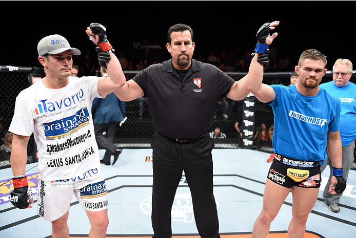 LAS VEGAS, NEVADA - DECEMBER 12: (R-L) Daron Cruickshank and KJ Noons receive a no contest after an accidental eye poke in their lightweight fight during The Ultimate Fighter Finale event inside the Pearl concert theater at the Palms Casino Resort on Dece
