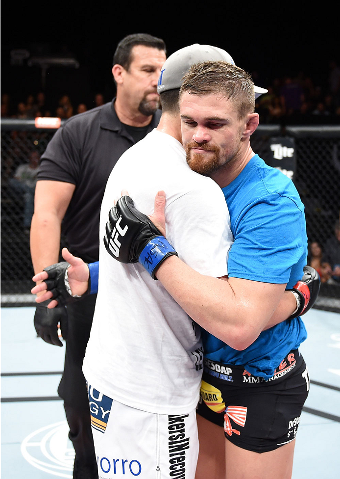 LAS VEGAS, NEVADA - DECEMBER 12: (R-L) Daron Cruickshank and KJ Noons hug after receiving a no contest after an accidental eye poke in their lightweight fight during The Ultimate Fighter Finale event inside the Pearl concert theater at the Palms Casino Re