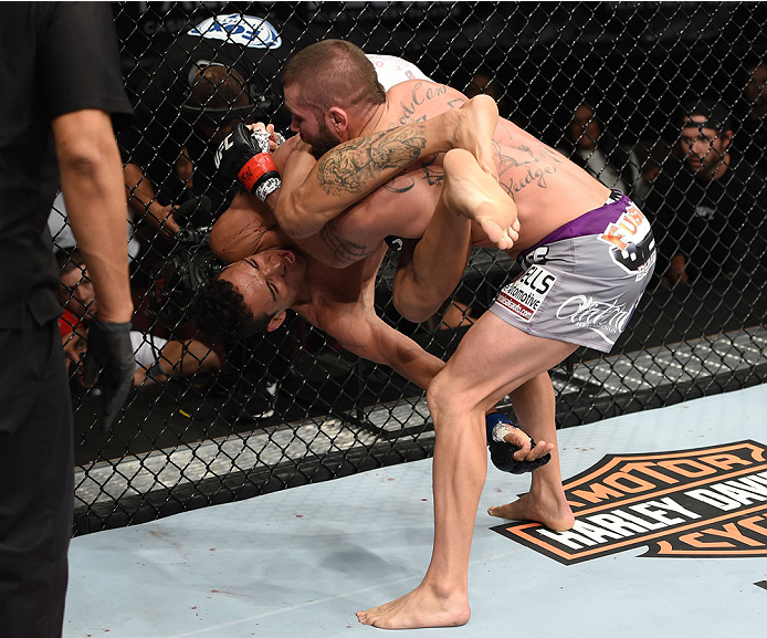 LAS VEGAS, NEVADA - DECEMBER 12: (R-L) Jeremy Stephens slams Charles Oliveira in their lightweight fight during The Ultimate Fighter Finale event inside the Pearl concert theater at the Palms Casino Resort on December 12, 2014 in Las Vegas, Nevada. (Phot