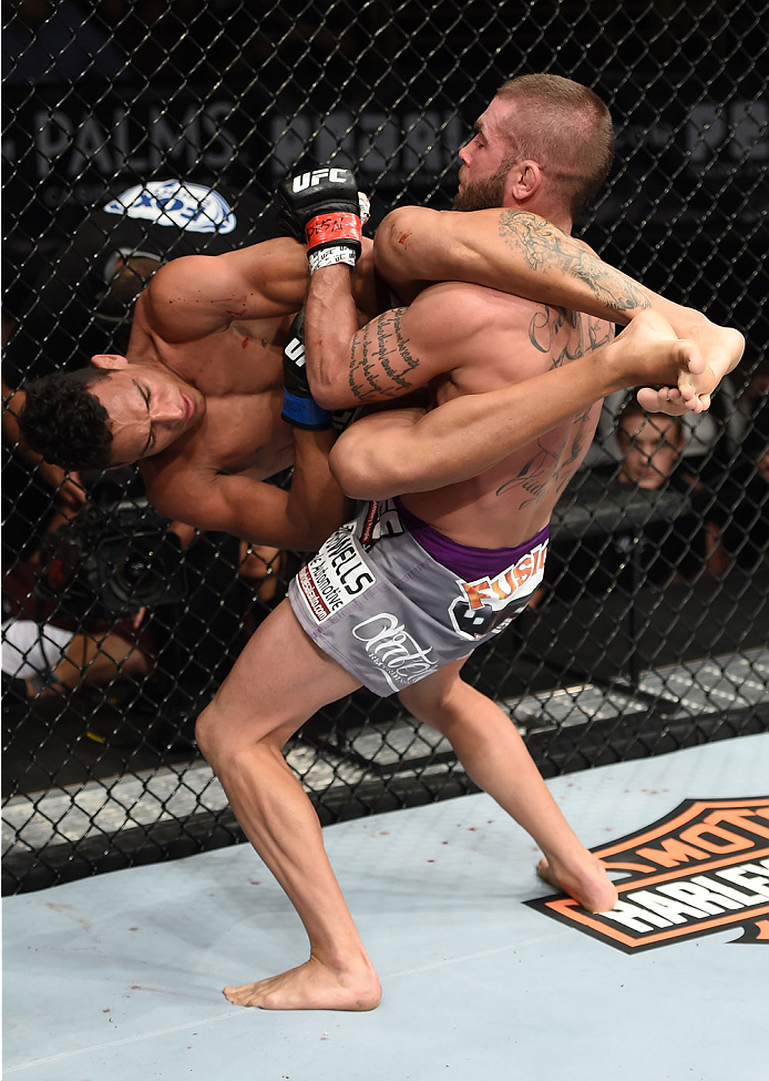 LAS VEGAS, NEVADA - DECEMBER 12: (R-L) Jeremy Stephens slams Charles Oliveira in their lightweight fight during The Ultimate Fighter Finale event inside the Pearl concert theater at the Palms Casino Resort on December 12, 2014 in Las Vegas, Nevada. (Phot