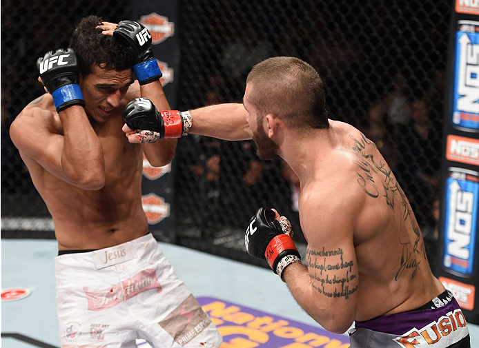 LAS VEGAS, NEVADA - DECEMBER 12: (R-L) Jeremy Stephens punches Charles Oliveira in their lightweight fight during The Ultimate Fighter Finale event inside the Pearl concert theater at the Palms Casino Resort on December 12, 2014 in Las Vegas, Nevada. (Ph