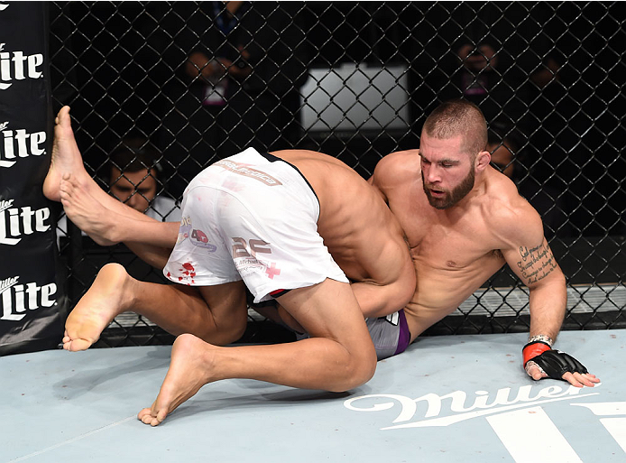 LAS VEGAS, NEVADA - DECEMBER 12: (L-R) Charles Oliveira takes down Jeremy Stephens in their lightweight fight during The Ultimate Fighter Finale event inside the Pearl concert theater at the Palms Casino Resort on December 12, 2014 in Las Vegas, Nevada.