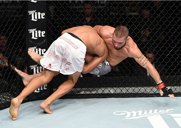 LAS VEGAS, NEVADA - DECEMBER 12: (L-R) Charles Oliveira takes down Jeremy Stephens in their lightweight fight during The Ultimate Fighter Finale event inside the Pearl concert theater at the Palms Casino Resort on December 12, 2014 in Las Vegas, Nevada.