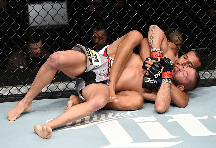 LAS VEGAS, NEVADA - DECEMBER 12: Charles Oliveira attempts to submit Jeremy Stephens in their lightweight fight during The Ultimate Fighter Finale event inside the Pearl concert theater at the Palms Casino Resort on December 12, 2014 in Las Vegas, Nevada