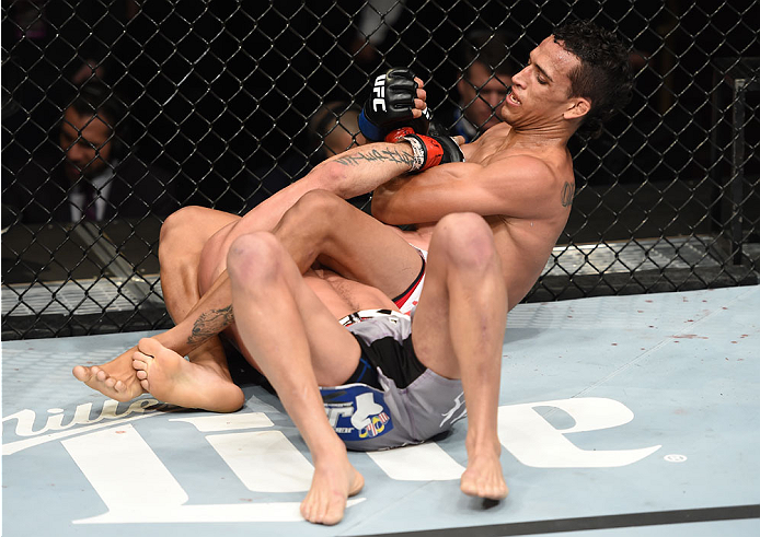 LAS VEGAS, NEVADA - DECEMBER 12: (R-L) Charles Oliveira attempts to submit Jeremy Stephens in their lightweight fight during The Ultimate Fighter Finale event inside the Pearl concert theater at the Palms Casino Resort on December 12, 2014 in Las Vegas,