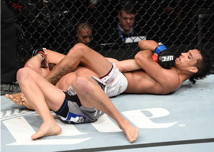 LAS VEGAS, NEVADA - DECEMBER 12: (R-L) Charles Oliveira attempts to submit Jeremy Stephens in their lightweight fight during The Ultimate Fighter Finale event inside the Pearl concert theater at the Palms Casino Resort on December 12, 2014 in Las Vegas,