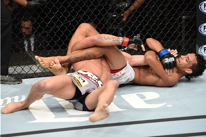 LAS VEGAS, NEVADA - DECEMBER 12: (R-L) Charles Oliveira attempts to submit Jeremy Stephens in their lightweight fight during The Ultimate Fighter Finale event inside the Pearl concert theater at the Palms Casino Resort on December 12, 2014 in Las Vegas,