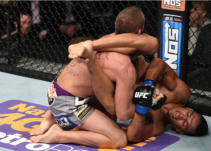 LAS VEGAS, NEVADA - DECEMBER 12: (R-L) Charles Oliveira attempts to submit Jeremy Stephens in their lightweight fight during The Ultimate Fighter Finale event inside the Pearl concert theater at the Palms Casino Resort on December 12, 2014 in Las Vegas,