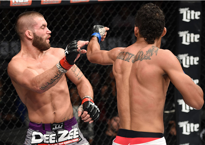 LAS VEGAS, NEVADA - DECEMBER 12: (R-L) Charles Oliveira punches Jeremy Stephens in their lightweight fight during The Ultimate Fighter Finale event inside the Pearl concert theater at the Palms Casino Resort on December 12, 2014 in Las Vegas, Nevada. (Pho