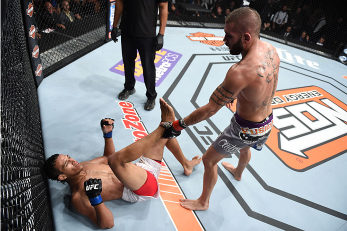 LAS VEGAS, NEVADA - DECEMBER 12: (R-L) Jeremy Stephens punches Charles Oliveira in their lightweight fight during The Ultimate Fighter Finale event inside the Pearl concert theater at the Palms Casino Resort on December 12, 2014 in Las Vegas, Nevada. (Pho