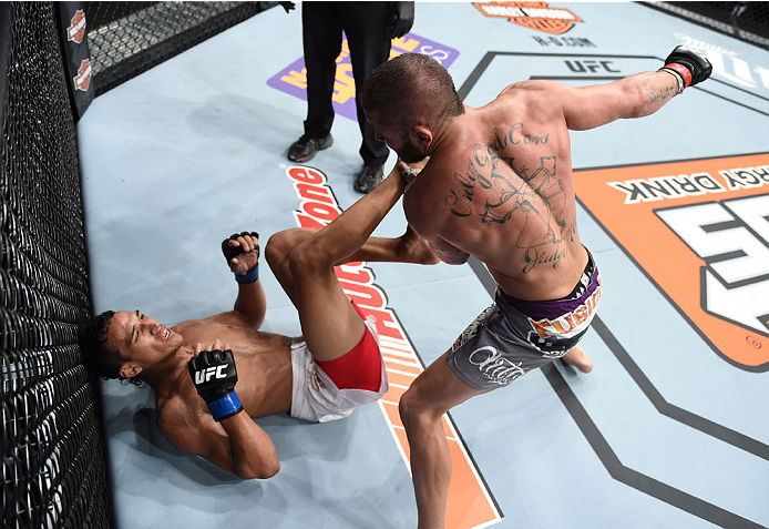 LAS VEGAS, NEVADA - DECEMBER 12: (R-L) Jeremy Stephens punches Charles Oliveira in their lightweight fight during The Ultimate Fighter Finale event inside the Pearl concert theater at the Palms Casino Resort on December 12, 2014 in Las Vegas, Nevada. (Pho