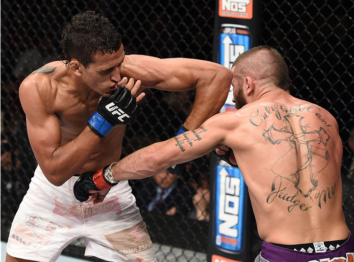 LAS VEGAS, NEVADA - DECEMBER 12: (L-R) Charles Oliveira elbows Jeremy Stephens in their lightweight fight during The Ultimate Fighter Finale event inside the Pearl concert theater at the Palms Casino Resort on December 12, 2014 in Las Vegas, Nevada. (Phot