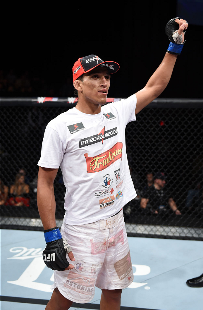 LAS VEGAS, NEVADA - DECEMBER 12: Charles Oliveira raises his hands after his fight against Jeremy Stephens in their lightweight fight during The Ultimate Fighter Finale event inside the Pearl concert theater at the Palms Casino Resort on December 12, 2014