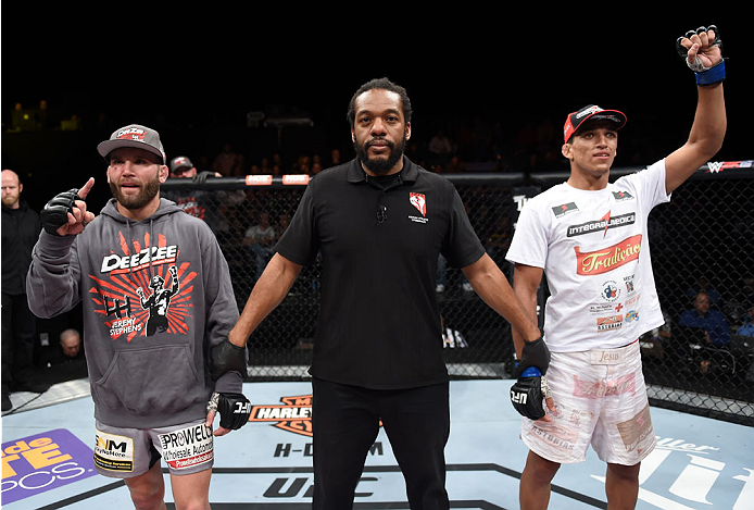 LAS VEGAS, NEVADA - DECEMBER 12: (R-L) Charles Oliveira raises his hands after his fight against Jeremy Stephens in their lightweight fight during The Ultimate Fighter Finale event inside the Pearl concert theater at the Palms Casino Resort on December 12
