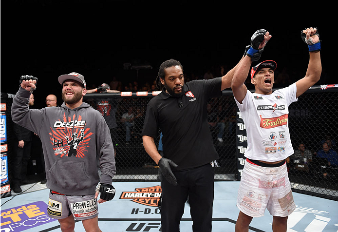 LAS VEGAS, NEVADA - DECEMBER 12: (R-L) Charles Oliveira celebrates his victory over Jeremy Stephens in their lightweight fight during The Ultimate Fighter Finale event inside the Pearl concert theater at the Palms Casino Resort on December 12, 2014 in Las