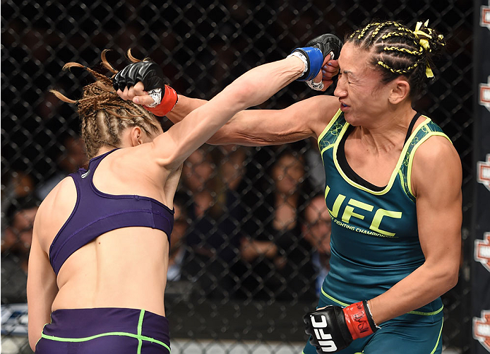 LAS VEGAS, NEVADA - DECEMBER 12: (L-R) Rose Namajunas exchanges punches with Carla Esparza in their strawweight championship fight during The Ultimate Fighter Finale event inside the Pearl concert theater at the Palms Casino Resort on December 12, 2014 in