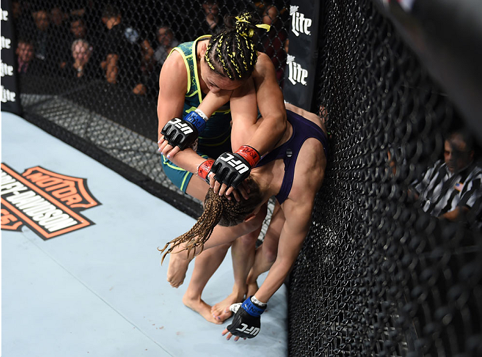 LAS VEGAS, NEVADA - DECEMBER 12: (L-R) Carla Esparza knees Rose Namajunas in their strawweight championship fight during The Ultimate Fighter Finale event inside the Pearl concert theater at the Palms Casino Resort on December 12, 2014 in Las Vegas, Nevad