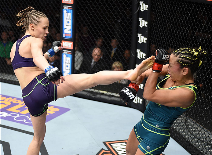 LAS VEGAS, NEVADA - DECEMBER 12: (L-R) Rose Namajunas kicks Carla Esparza in their strawweight championship fight during The Ultimate Fighter Finale event inside the Pearl concert theater at the Palms Casino Resort on December 12, 2014 in Las Vegas, Nevad