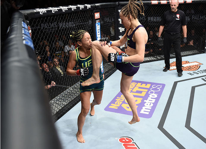 LAS VEGAS, NEVADA - DECEMBER 12: (R-L) Rose Namajunas knees Carla Esparza in their strawweight championship fight during The Ultimate Fighter Finale event inside the Pearl concert theater at the Palms Casino Resort on December 12, 2014 in Las Vegas, Nevad