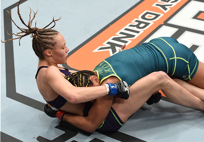 LAS VEGAS, NEVADA - DECEMBER 12: Carla Esparza (top) takes down Rose Namajunas in their strawweight championship fight during The Ultimate Fighter Finale event inside the Pearl concert theater at the Palms Casino Resort on December 12, 2014 in Las Vegas,