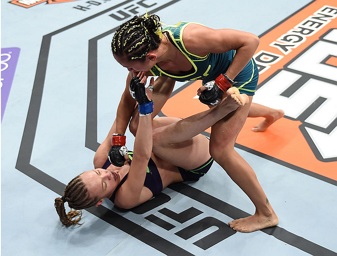 LAS VEGAS, NEVADA - DECEMBER 12: Carla Esparza (top) punches Rose Namajunas in their strawweight championship fight during The Ultimate Fighter Finale event inside the Pearl concert theater at the Palms Casino Resort on December 12, 2014 in Las Vegas, Nev