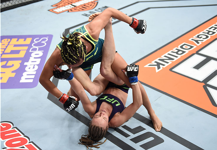 LAS VEGAS, NEVADA - DECEMBER 12: Carla Esparza (top) punches Rose Namajunas in their strawweight championship fight during The Ultimate Fighter Finale event inside the Pearl concert theater at the Palms Casino Resort on December 12, 2014 in Las Vegas, Nev