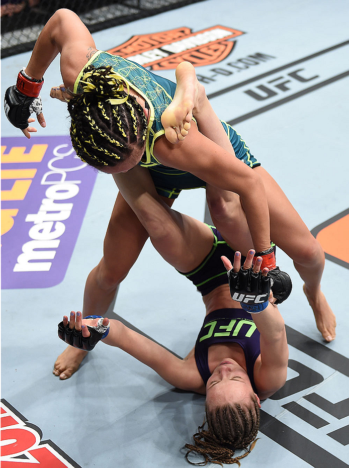 LAS VEGAS, NEVADA - DECEMBER 12: Carla Esparza (top) punches Rose Namajunas in their strawweight championship fight during The Ultimate Fighter Finale event inside the Pearl concert theater at the Palms Casino Resort on December 12, 2014 in Las Vegas, Nev