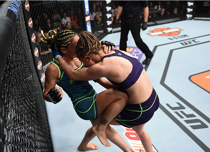 LAS VEGAS, NEVADA - DECEMBER 12: (L-R) Carla Esparza knees Rose Namajunas in their strawweight championship fight during The Ultimate Fighter Finale event inside the Pearl concert theater at the Palms Casino Resort on December 12, 2014 in Las Vegas, Neva